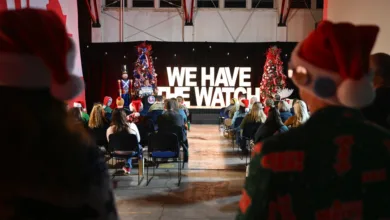 NORAD Tracks Santa event with "WE HAVE THE WATCH" banner and Christmas trees.