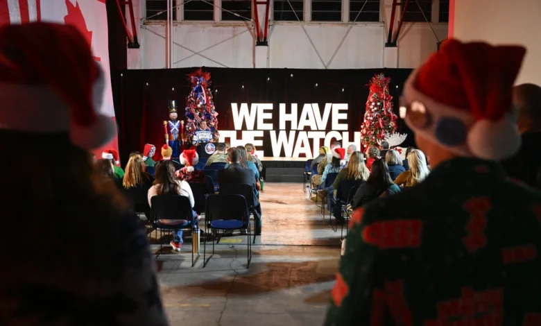 NORAD Tracks Santa event with "WE HAVE THE WATCH" banner and Christmas trees.