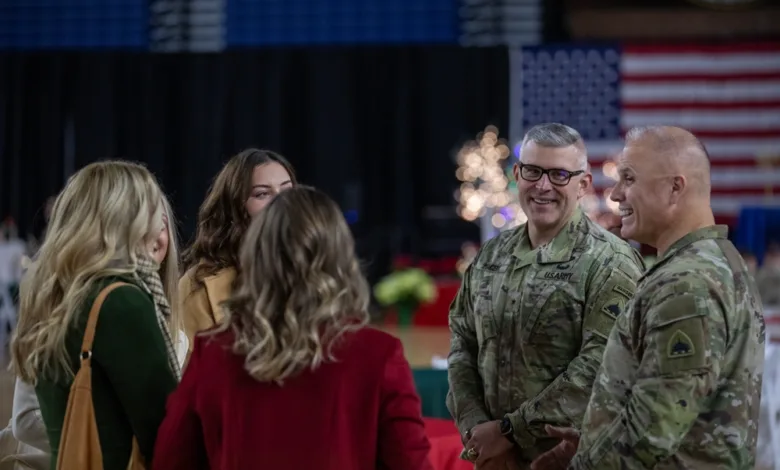 Army Guard members share a holiday meal, celebrating together in uniform with families and friends.