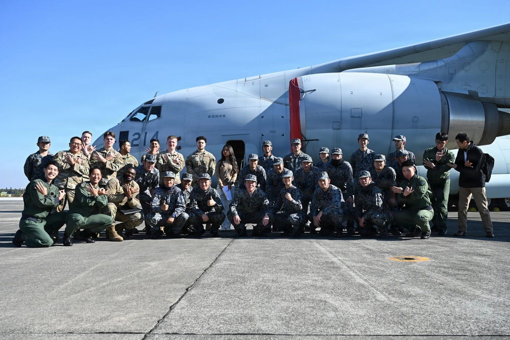 Group photo of US and Japanese service members in front of a C-130 at Yokota Air Base. Allied Partnership.