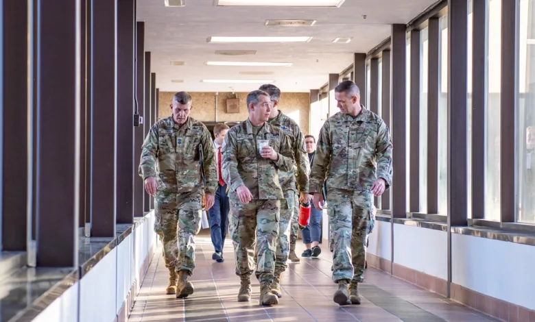 Combat Forces Command commander visits Schriever S.F.B., walking in a corridor.