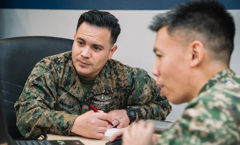 U.S. Marine and Malaysian Armed Forces member collaborating during CARAT 2025 exercise.