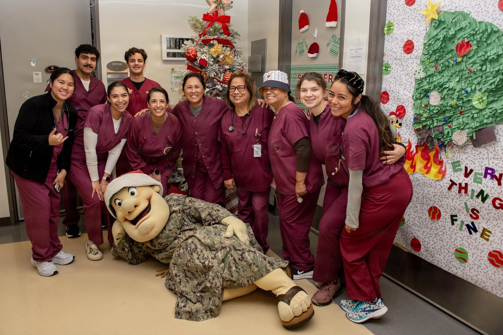 NMCSD staff with the San Diego Padres mascot during a holiday visit.