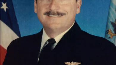 Capt. Roger Hill in US Navy uniform with ribbons and insignia, honoring his service at NAS Patuxent River.