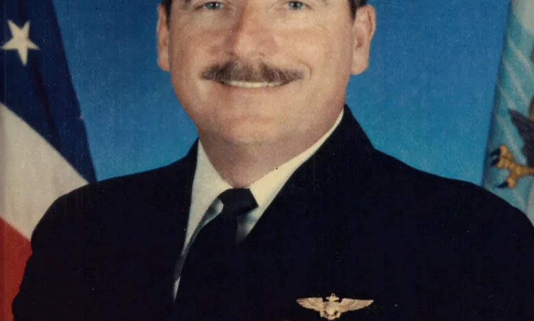 Capt. Roger Hill in US Navy uniform with ribbons and insignia, honoring his service at NAS Patuxent River.