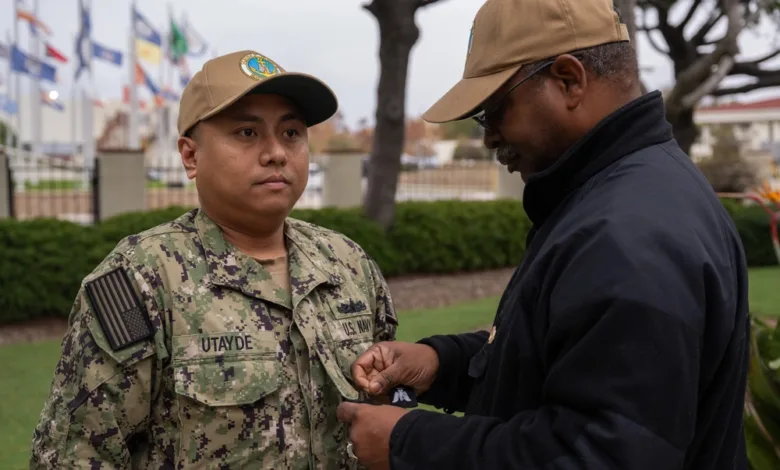 Sailor receiving rank insignia at Naval Base San Diego frocking ceremony.