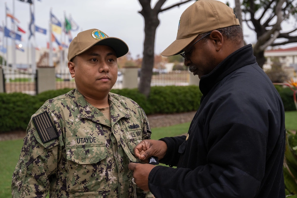 Sailor receiving rank insignia at Naval Base San Diego frocking ceremony.