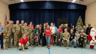 Group photo of volunteers serving veterans at a holiday event.