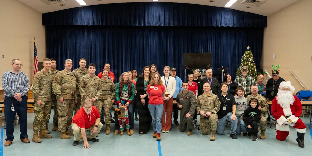 Group photo of volunteers serving veterans at a holiday event.