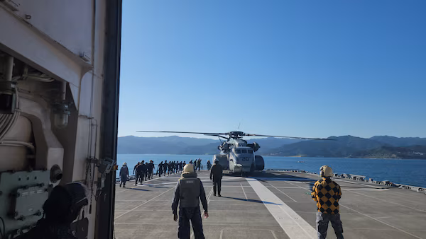 U.S. and Japan naval forces on deck with helicopter, 3JA 2025 exercise.