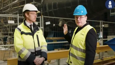 Saab A26 submarine construction: engineers in hard hats and vests.