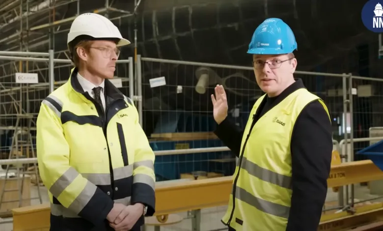 Saab A26 submarine construction: engineers in hard hats and vests.