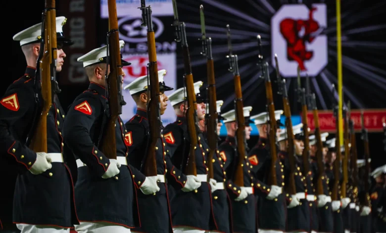 US Marines rifle drill team at attention during a ceremony.