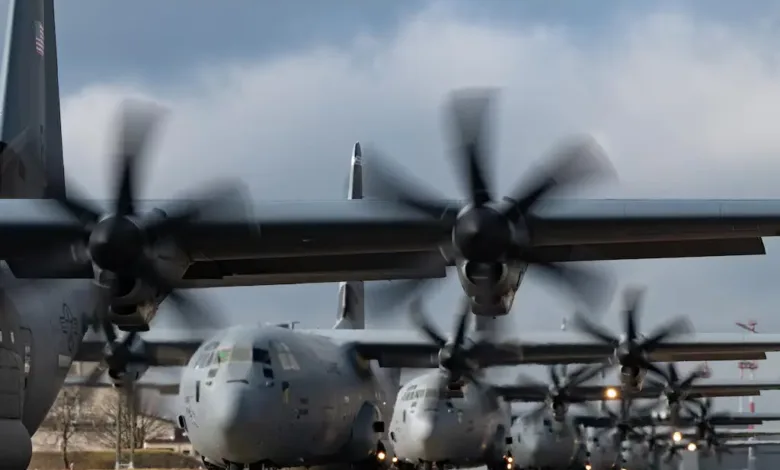 Line of C-130J military cargo planes on runway, undergoing upgrades.
