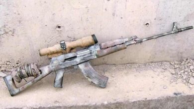 Camouflaged AK-pattern Iraqi Designated Marksman Rifle (DMR) with scope and makeshift stock modification.