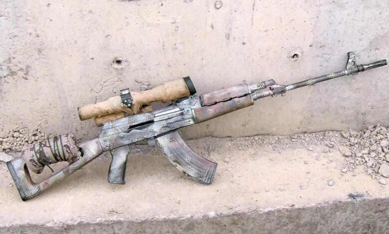 Camouflaged AK-pattern Iraqi Designated Marksman Rifle (DMR) with scope and makeshift stock modification.