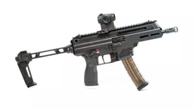 Springfield Armory Kuna pistol with brace and red dot sight on a white background.