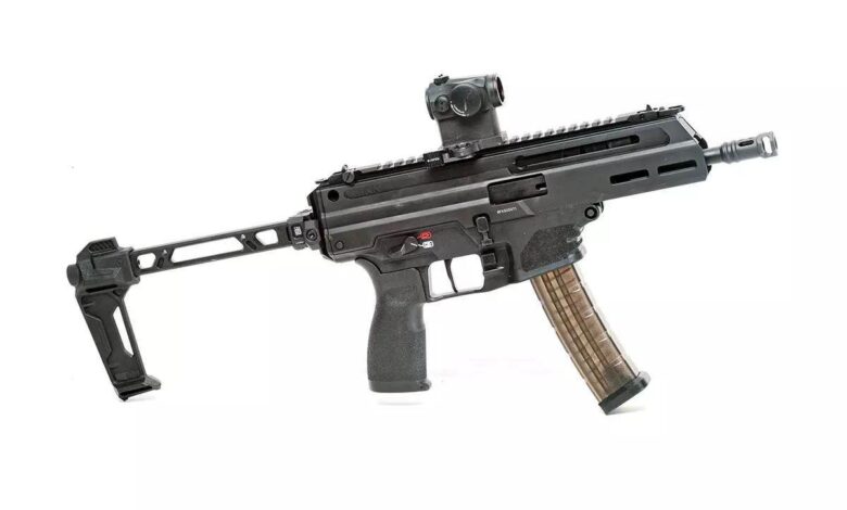 Springfield Armory Kuna pistol with brace and red dot sight on a white background.