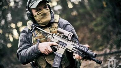 Man holding a J&C Armament Black Widow Mk.III PDW with tactical gear.