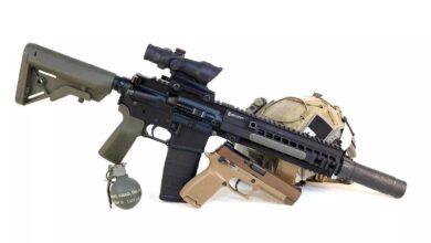 HK 416 build with Brownells BRN4 upper, pistol, grenade, and tactical helmet on a white background.