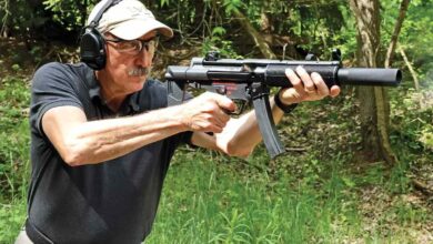 Man shooting a Century Arms AP5-SD MP5 clone with suppressor and ear protection.