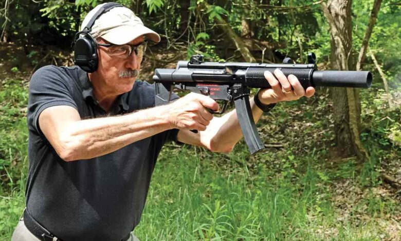 Man shooting a Century Arms AP5-SD MP5 clone with suppressor and ear protection.