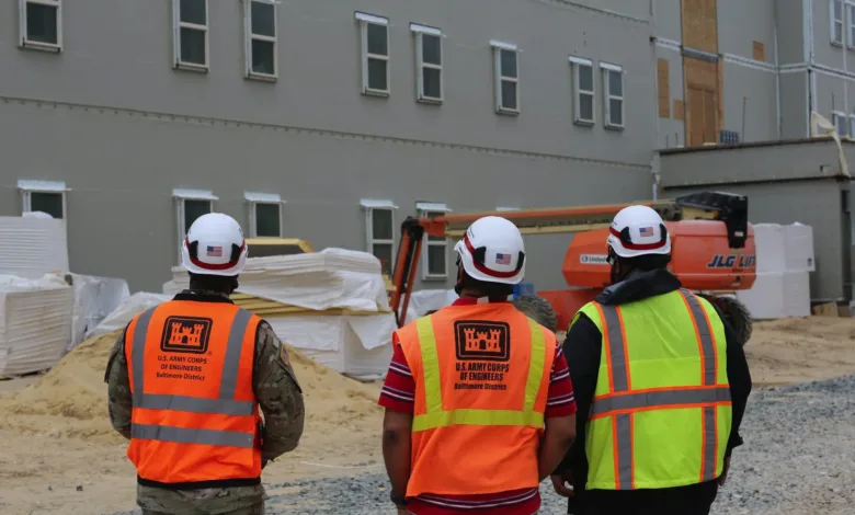 Army Corps of Engineers inspecting barracks construction site.