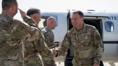 Gen. Lamontagne arrives, shaking hands with Air Force personnel. "U.S. Air Force" visible on uniform.