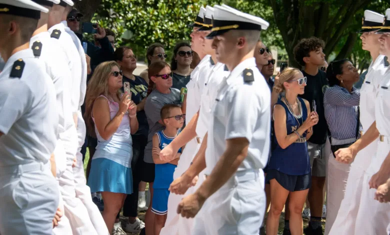 Naval cadets marching past spectators, possibly related to USAA relief loans.