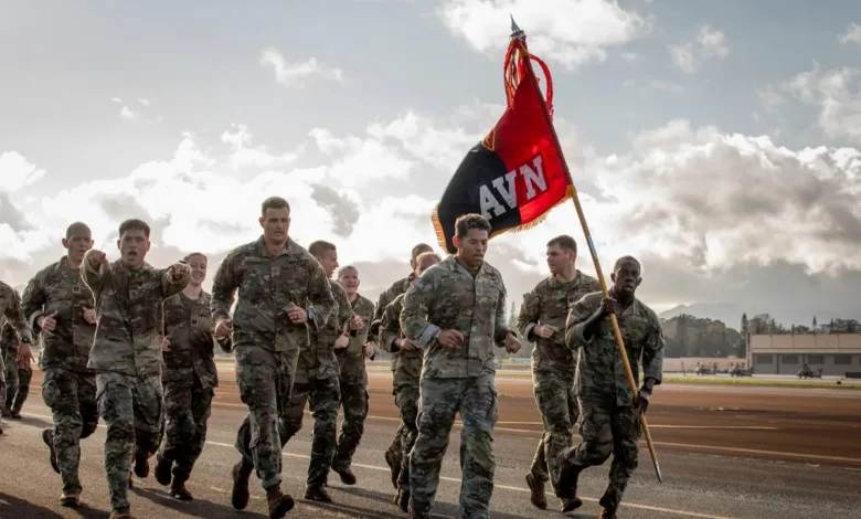 Army soldiers running with AVN flag, military training exercise.