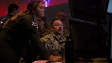Air Force personnel monitor screens during an AI and joint integration test for battle management.
