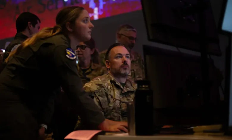 Air Force personnel monitor screens during an AI and joint integration test for battle management.