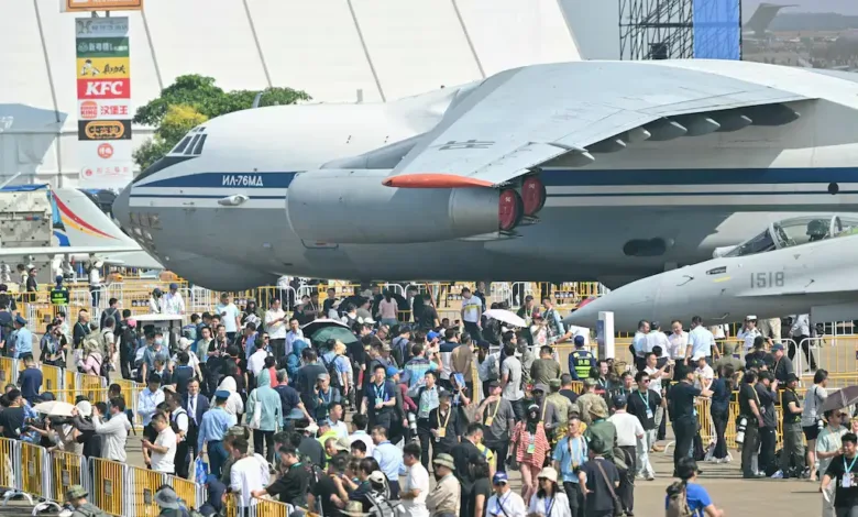 Crowd at airshow with a large Russian Il-76MA cargo plane in background.