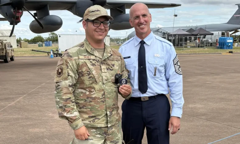 Two Air Force members pose in front of a B-52 Stratofortress. Perez is wearing OCPs.