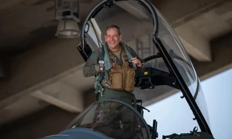 Air Force General Wilsbach in fighter jet cockpit, smiling.