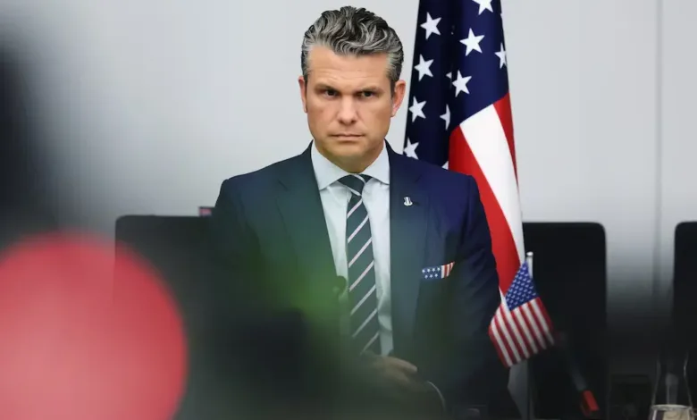 Matt Gaetz at a meeting with US flags in background.
