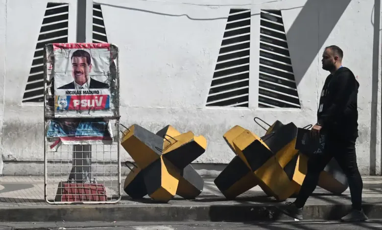 Nicolás Maduro poster in Caracas, next to barriers. Russian plane flew to Cuba, Nicaragua after this stop.