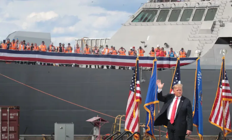 Donald Trump waves at a US Navy ship commissioning ceremony.