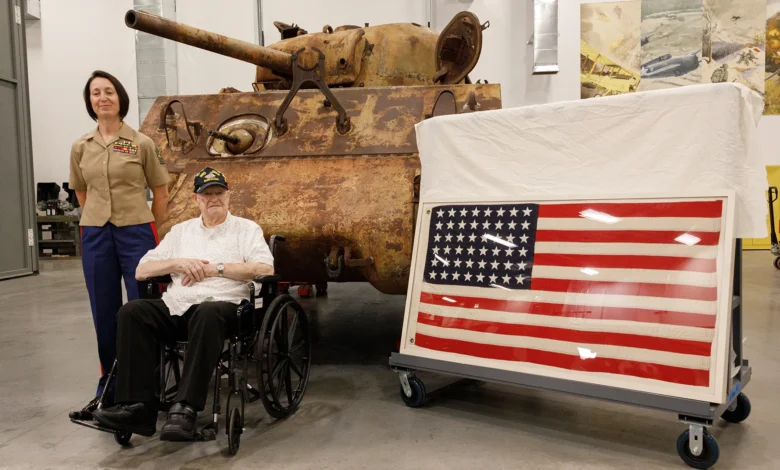 WWII Marine veteran with Iwo Jima tank and 48-star flag