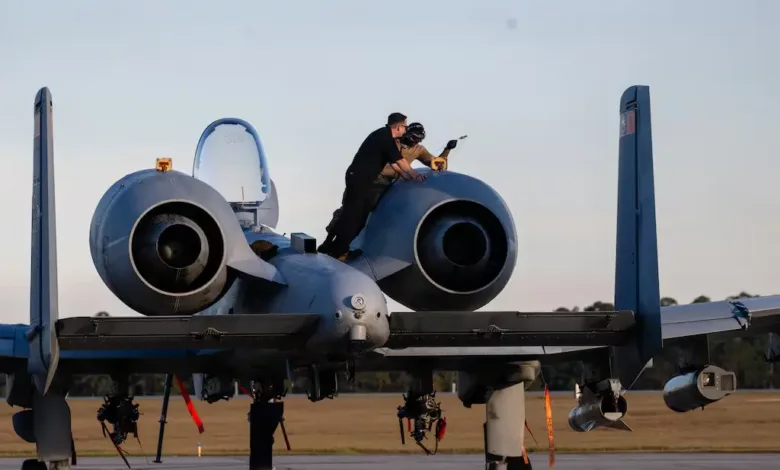 A-10 Thunderbolt II being inspected by Air Force personnel, preparing for future war operations.