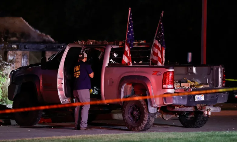 FBI agent near a truck with American flags, possibly related to weekend violence involving Marine veterans.