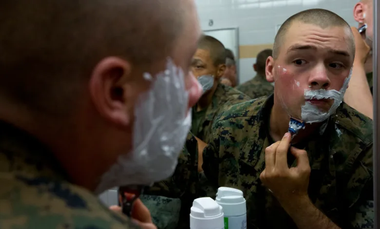 Marines shaving in a barracks bathroom mirror. Military grooming.