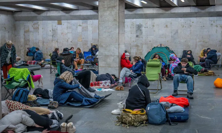 People sheltering in a Ukrainian metro station, seeking refuge during the conflict.