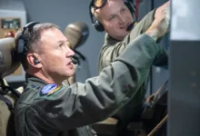 Airmen in cockpit, possibly related to Air Mobility Command leadership change.
