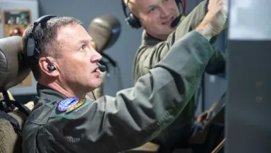 Airmen in cockpit, possibly related to Air Mobility Command leadership change.