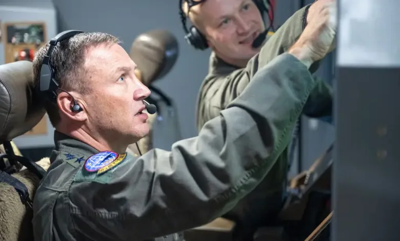 Airmen in cockpit, possibly related to Air Mobility Command leadership change.