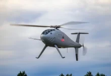 Schiebel Camcopter S-300 in flight. Unmanned helicopter drone in the sky.