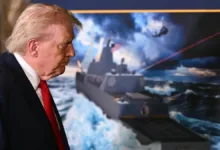 Donald Trump views a rendering of a new Navy battleship with lasers, possibly related to news of new battleships.