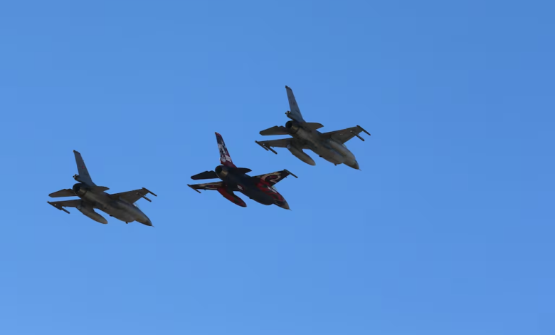 Three Turkish Air Force F-16 fighter jets in flight, one with special red and black markings.