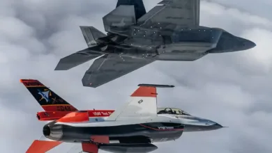 US Air Force F-22 Raptor and VISTA X-62A experimental AI fighter jet in flight.